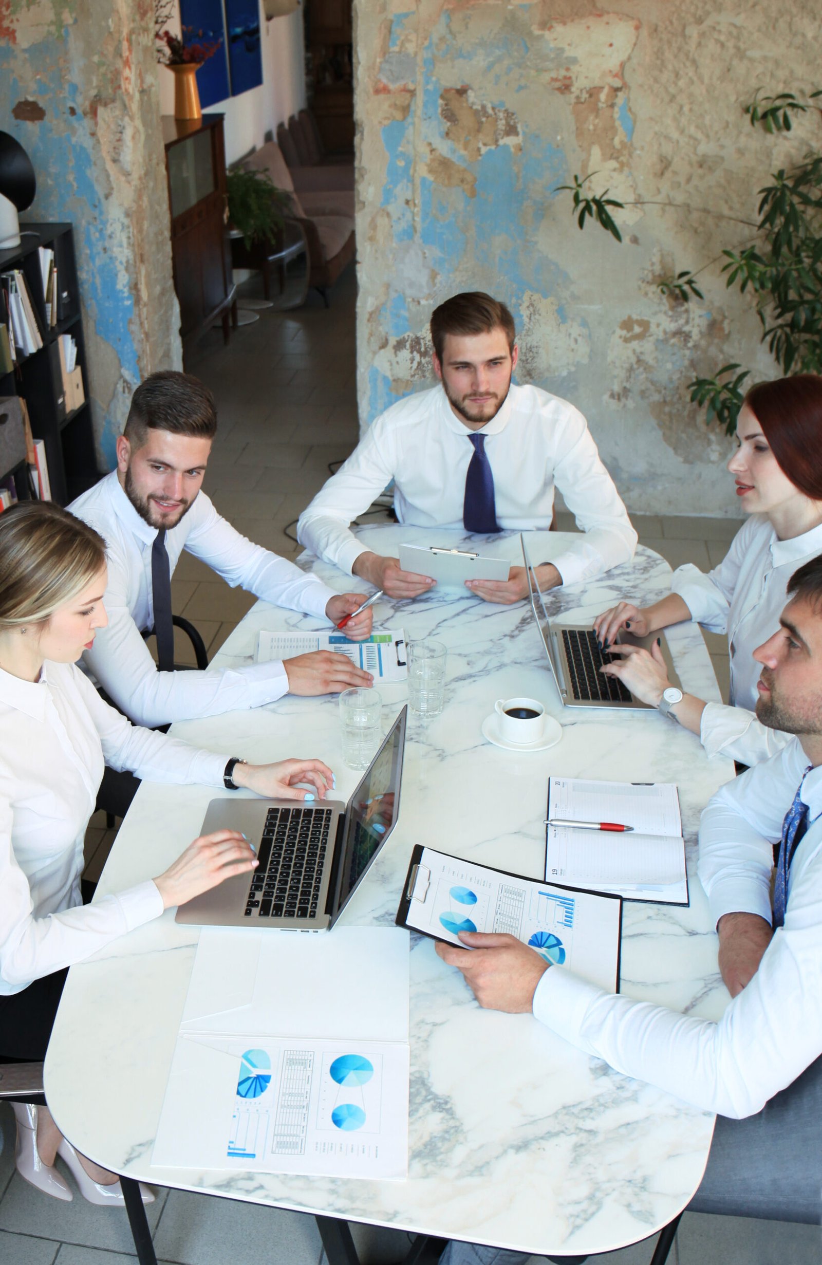 Top view of business people working together while spending time in the office